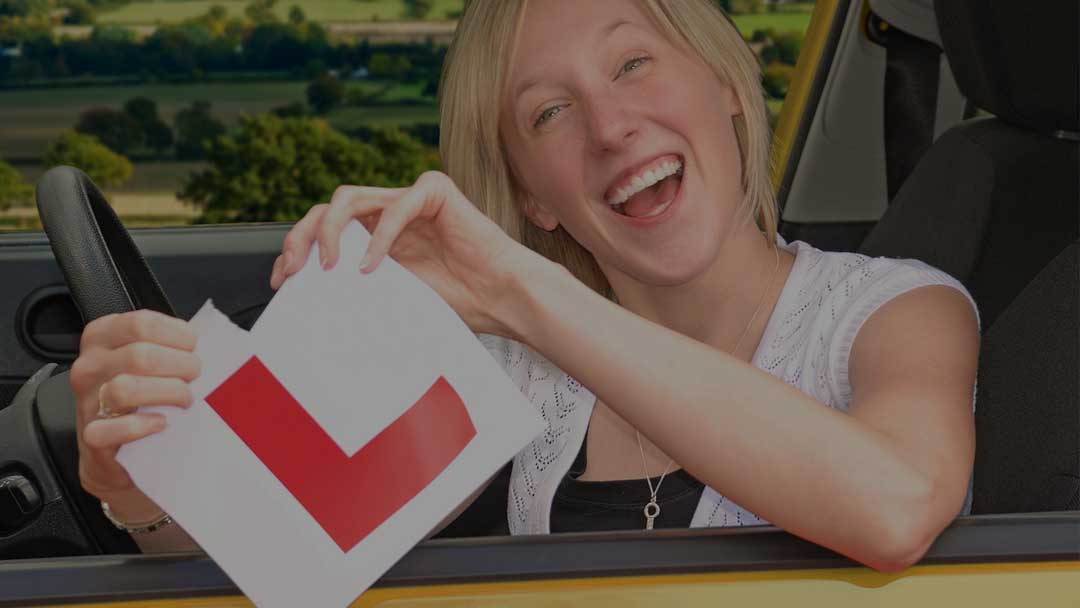 A student celebrating after passing her driving test